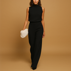 Women’s elegant halter jumpsuit with wide legs, high waist, and decorative bow detail, perfect for parties, dinners, and evening outings.