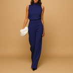 Women’s elegant halter jumpsuit with wide legs, high waist, and decorative bow detail, perfect for parties, dinners, and evening outings.